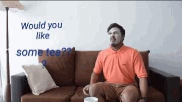 a man is sitting on a couch with a mask on his face and the words " would you like some tea " behind him