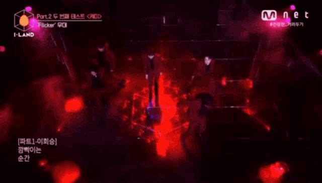 a group of people are dancing on a stage with purple lights behind them