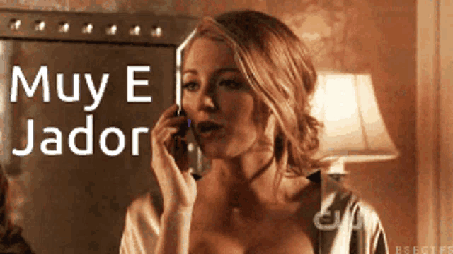 a woman is talking on a cell phone and the words muy e jador are behind her
