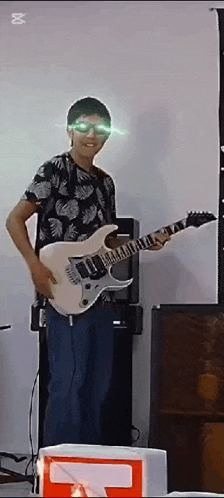 a man wearing sunglasses is holding a guitar