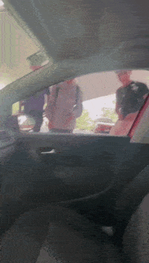 a man in a purple shirt is talking to another man in a red shirt