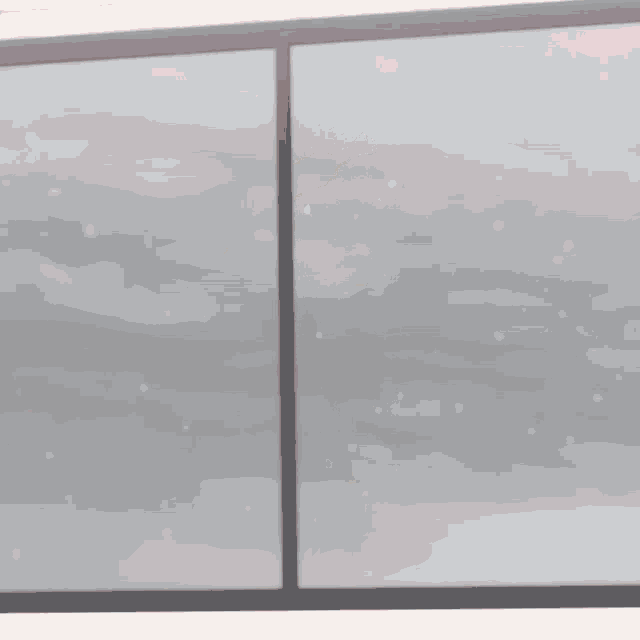 a girl in a yellow jacket is standing on a window sill with her arms outstretched