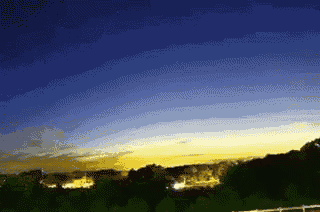 a sunset with a blue sky and yellow clouds