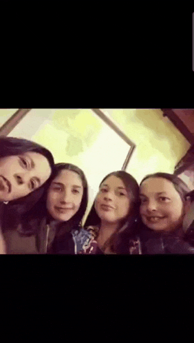 a group of girls are posing for a picture together .