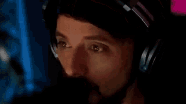 a man with a beard wearing headphones and a microphone .