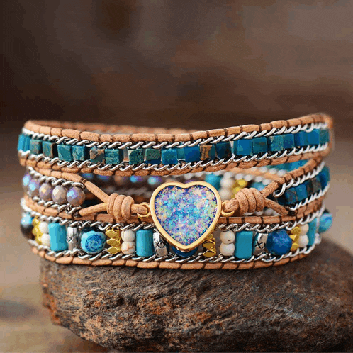 a bracelet with turquoise beads and a heart shaped opal