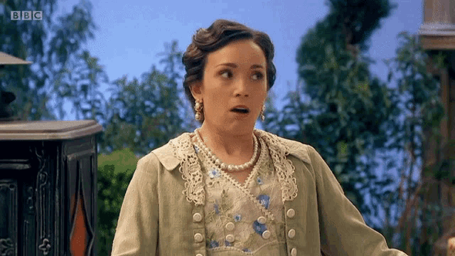a woman with a surprised look on her face is featured on bbc television