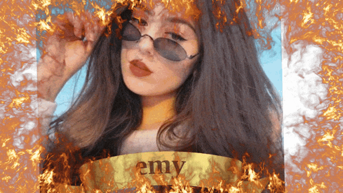 a woman wearing sunglasses is surrounded by flames and the name emy is visible