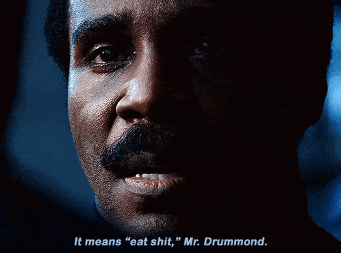 a man with a mustache is saying it means " eat shit "