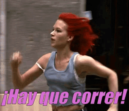 a woman with red hair is running with the words hay que correr in pink