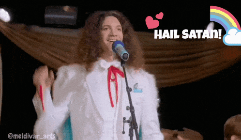 a man in a white suit singing into a microphone with the words hail satan below him