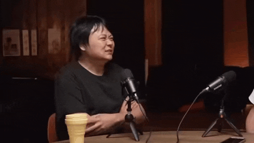 a man fist bumps another man in front of microphones that say sennheiser