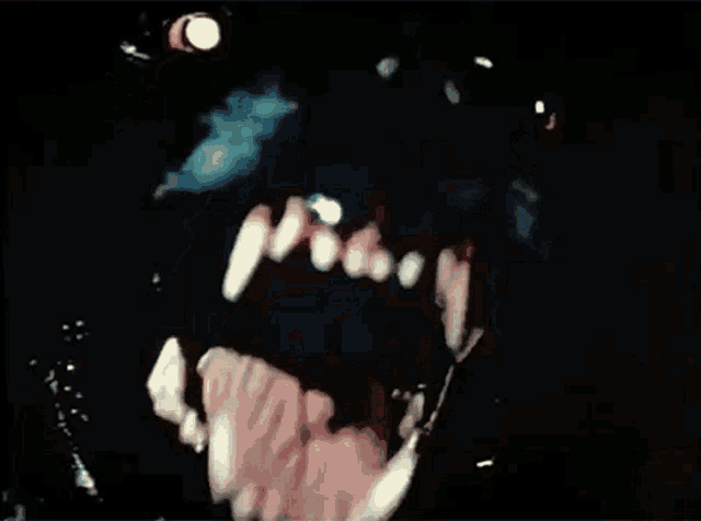 a close up of a person 's mouth and teeth with a light in the background
