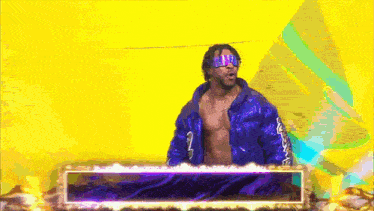 a man in a blue jacket with the number 2 on it stands in front of a yellow background