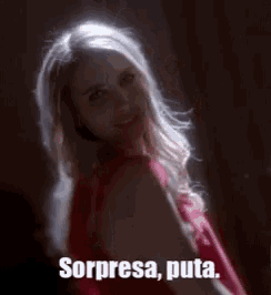a woman in a red dress with the words sorpresa puta written below her