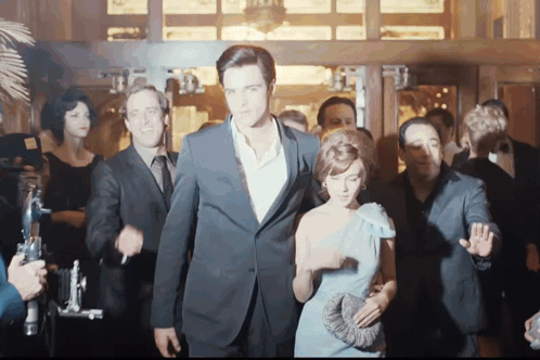Elvis And Priscilla Walking Out With Photographers Behind Them Priscilla Film GIF - Elvis And Priscilla Walking Out With Photographers Behind Them Priscilla Film Priscilla GIFs