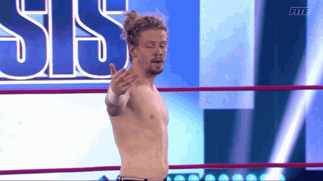a shirtless wrestler in a ring with the letters rte on the bottom