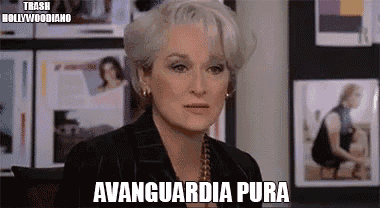 a woman with gray hair is standing in front of a wall with pictures and the words avantia pura on it .