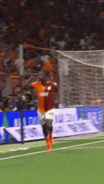 a soccer player wearing a jersey with the number 23 on it jumps in the air