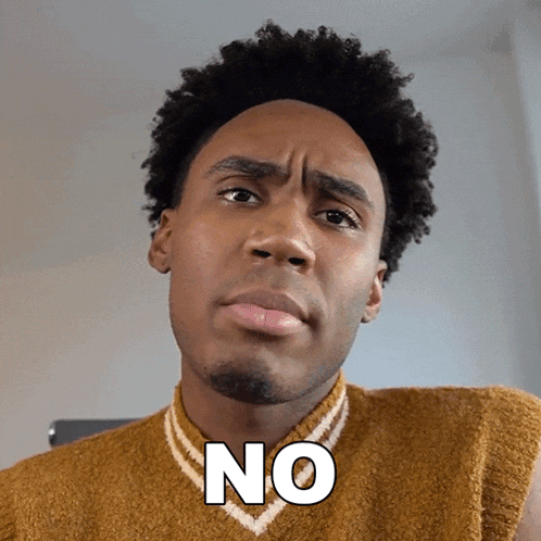 a man wearing a sweater has the word no on his chest