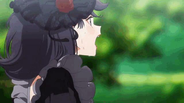 a girl in a black dress with a flower in her hair is crying