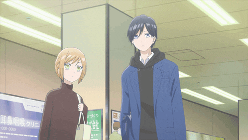 a man and a woman are standing in front of a sign that says 00-0000