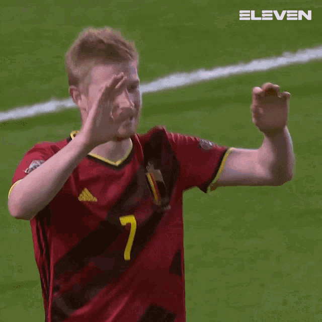 a man wearing a red jersey with the number 7 on it