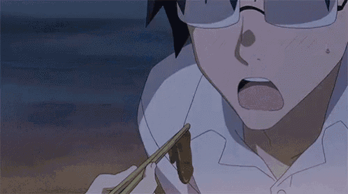 a close up of a person holding chopsticks and eating something .