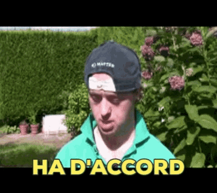 a man wearing a hat and a green shirt says " ha d' accord " in yellow letters