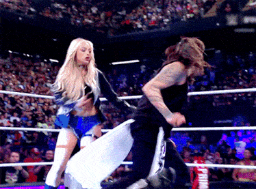 a woman in a wrestling ring with a sign that says prime on it