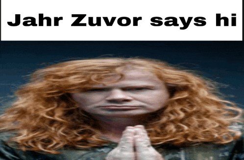 a red haired man with his hands folded and the words jahr zuvor says hi above him