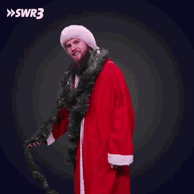 a man dressed as santa claus is holding a christmas tree tinsel