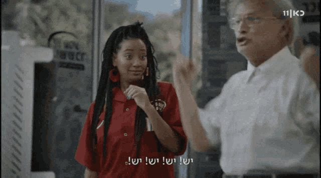 a woman in a red shirt is talking to a man in a white shirt with the number 11 on it