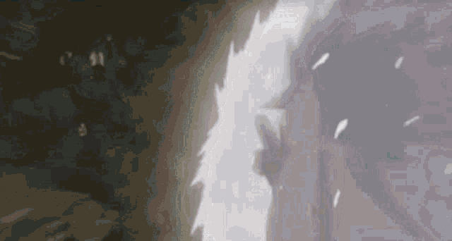 a person is standing in a dark room with a light coming out of the corner .