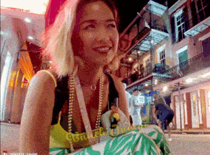 a woman wearing a necklace that says ' brunch queen '