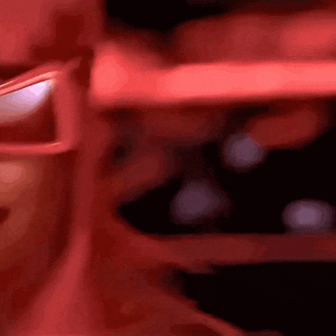 a close up of a red object with a blurred background .