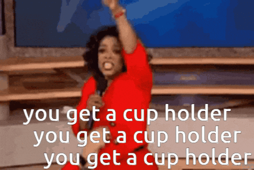 a woman in a red dress is holding a microphone and saying you get a cup holder you get a cup holder