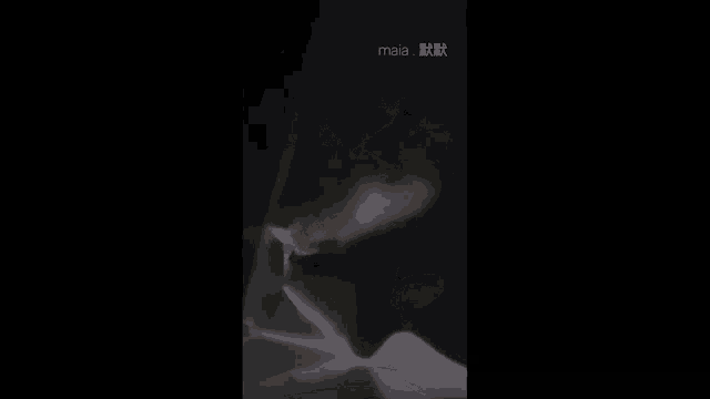 a close up of a person 's face in a dark room