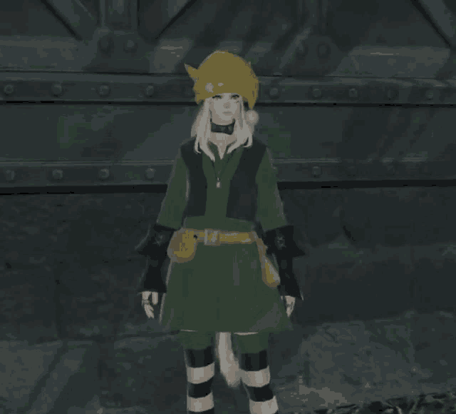 a woman in a green dress and a yellow hat is standing in front of a metal wall .