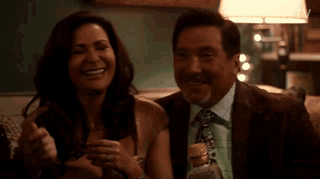 a man and a woman are sitting next to each other and smiling ..