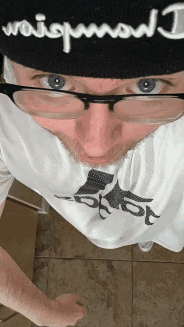 a man wearing glasses and a beanie that says ' waistband ' on it