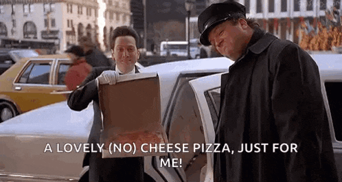 a man is holding a box of pizza in front of a limo .