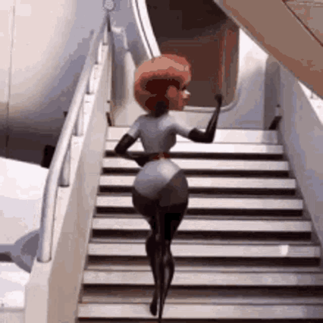 a woman is walking up a set of stairs .