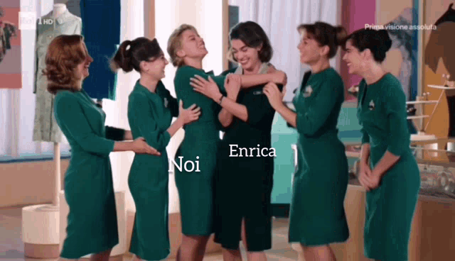 a group of women in green dresses are hugging each other with the name enrica on the bottom right