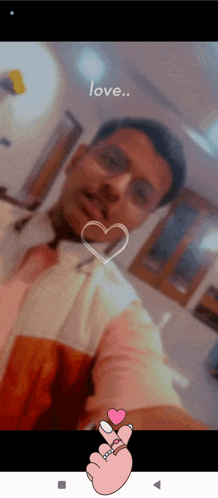 a man is taking a selfie with a heart in the background and the words love written above him