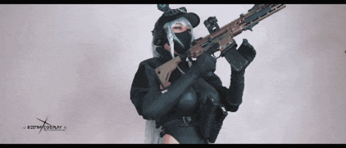 a woman holding a rifle with the word cosplay on the bottom right corner