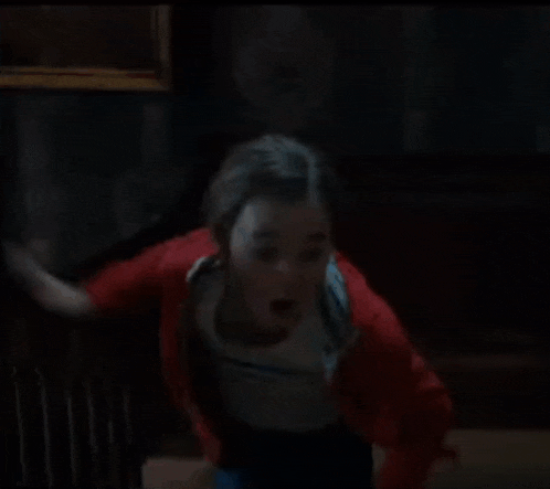 a blurry picture of a person in a red jacket .