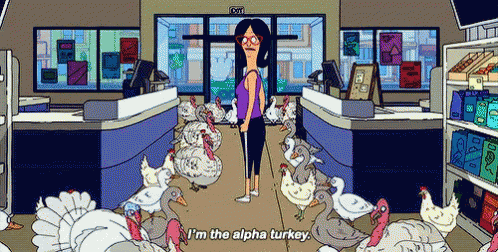 a woman is standing in a grocery store surrounded by turkeys .