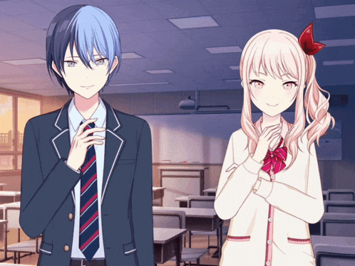 a boy and a girl are standing in a classroom with their hands folded