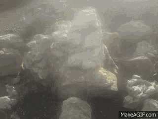 a pile of rocks with smoke coming out of them on make a gif